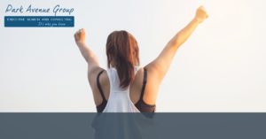 a women standing backwards with her arms up cheering
